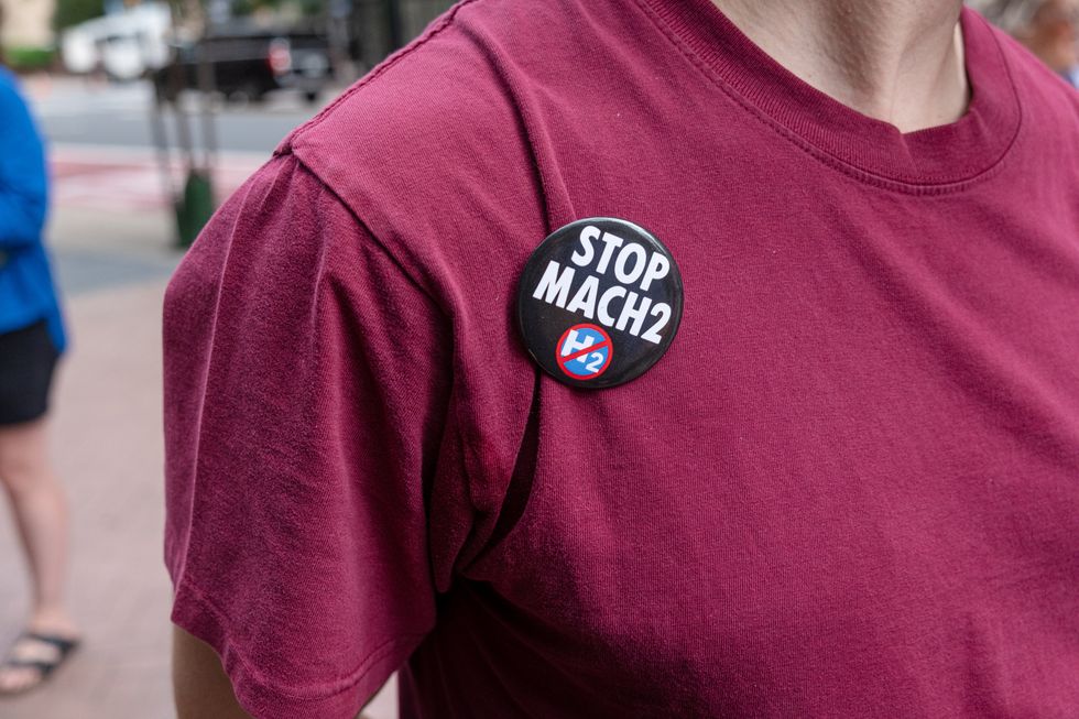 \u200bCommunity member with a STOP MACH2 button outside of the SEPTA (public transit agency) Headquarters in Philadelphia, PA