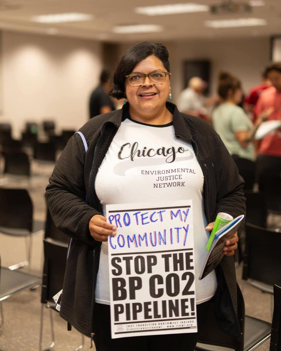 woman holding a "protect my community sign"