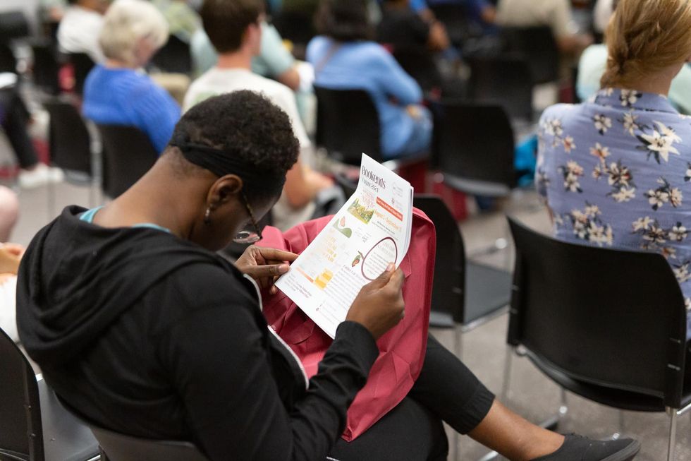 Woman looking at materials at an event about the Midwest hydrogen hub organized by Just Transition NWI in August 2024.